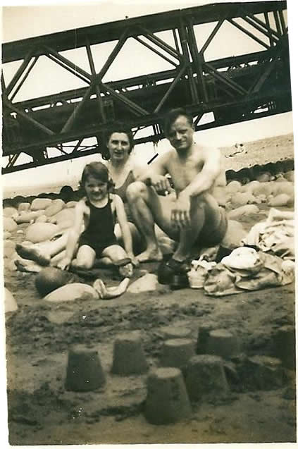 fam-and-sandcastle-near-bridge